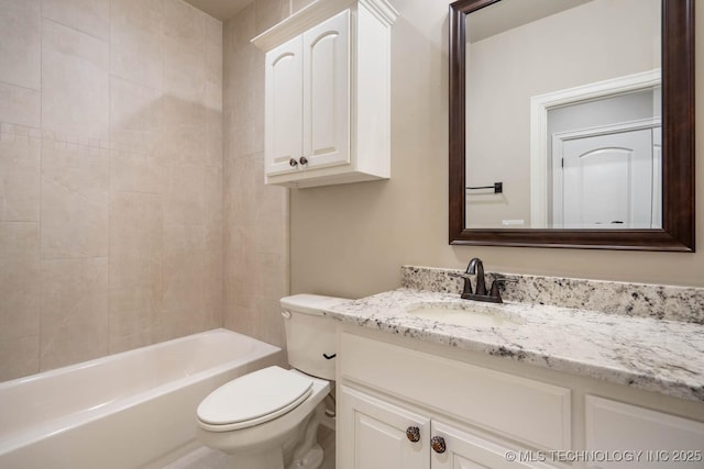 full bathroom featuring toilet, vanity, and tiled shower / bath