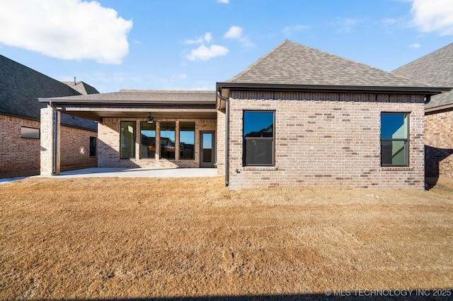 back of house featuring ceiling fan, a lawn, and a patio