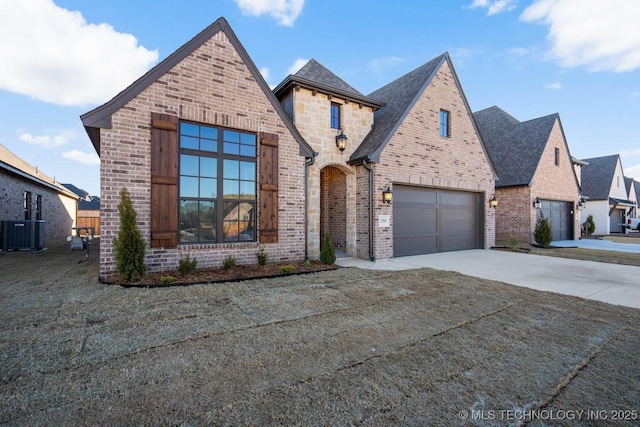 view of front of property featuring central AC unit and a garage