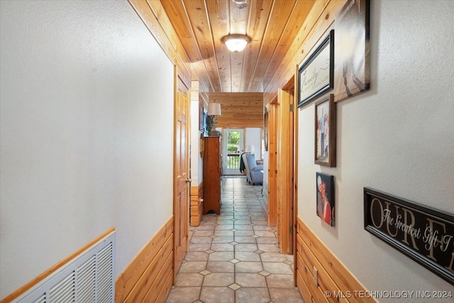 9212 N 447th Rd, Spavinaw, OK 74366 - hallway featuring visible vents, light tile patterned floors, wood walls, and wood ceiling