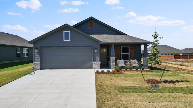 craftsman-style house featuring a front lawn and a garage