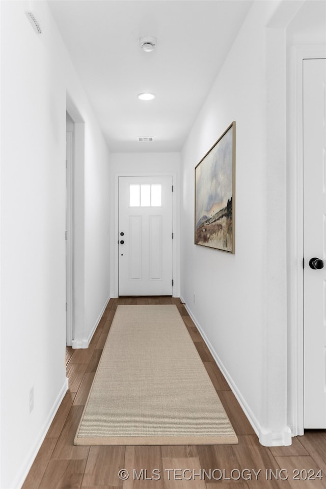 doorway with hardwood / wood-style flooring