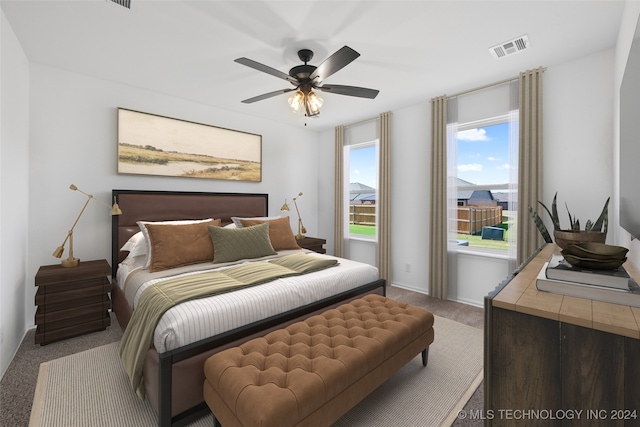 bedroom featuring ceiling fan and light carpet