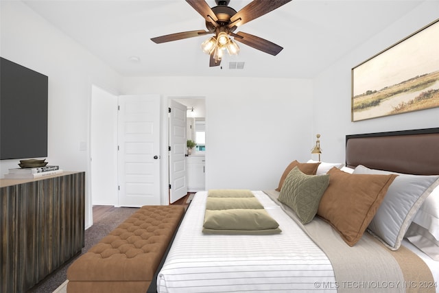 bedroom featuring ceiling fan and ensuite bath