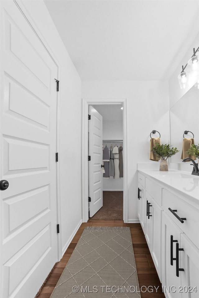 bathroom with hardwood / wood-style floors and vanity