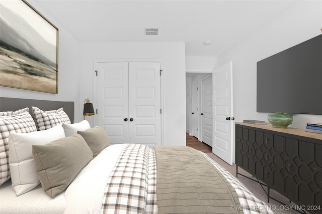 bedroom featuring a closet and dark hardwood / wood-style flooring