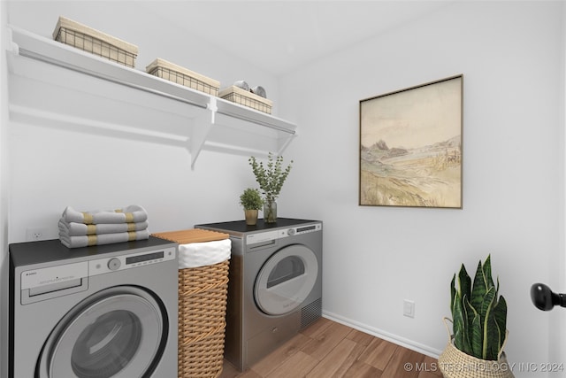 laundry room with hardwood / wood-style flooring and independent washer and dryer