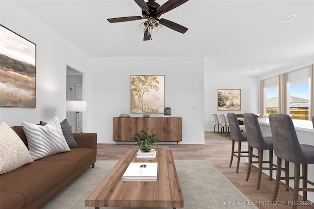 living room featuring ceiling fan and light hardwood / wood-style floors