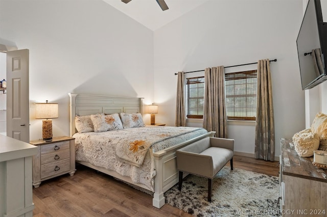 bedroom featuring hardwood / wood-style floors, high vaulted ceiling, and ceiling fan