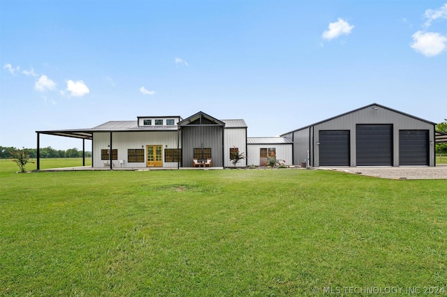 exterior space with a garage, a yard, and an outbuilding