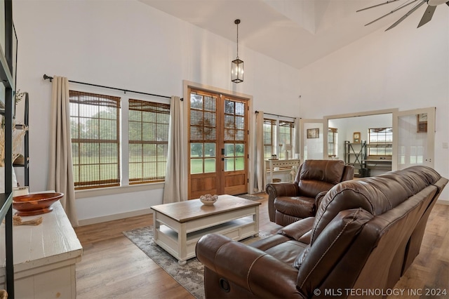 living room with high vaulted ceiling, light wood-type flooring, and ceiling fan