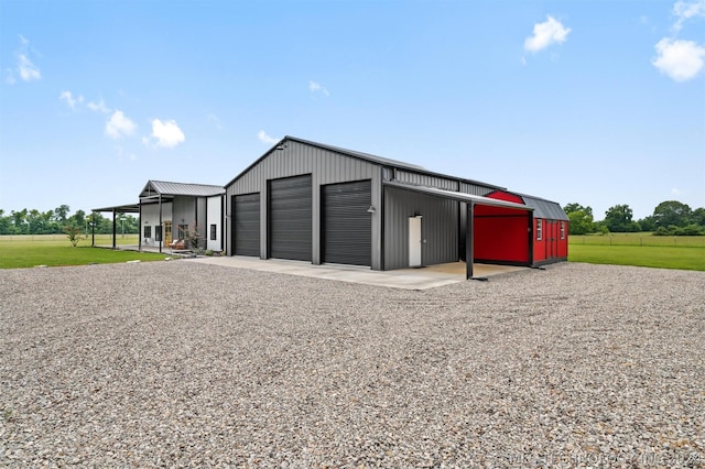 view of outdoor structure featuring a garage and a lawn