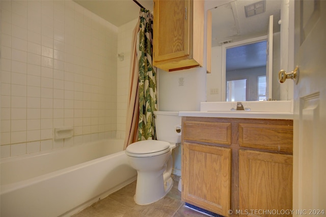 full bathroom featuring vanity, shower / bathtub combination with curtain, tile patterned floors, and toilet