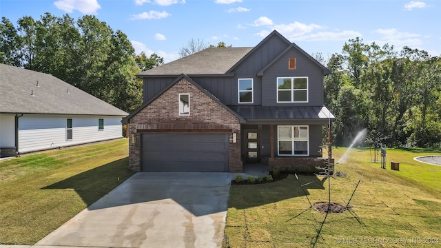 view of front of property with a front yard and a garage