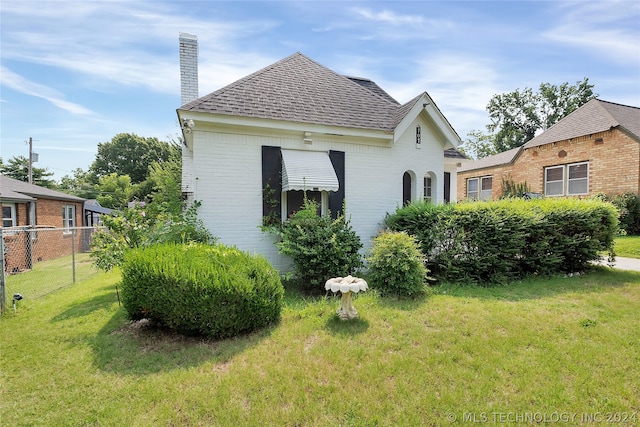 view of home's exterior with a yard