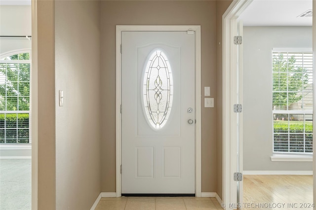 foyer entrance featuring plenty of natural light and light tile patterned floors