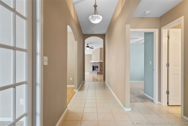 corridor featuring light tile patterned flooring