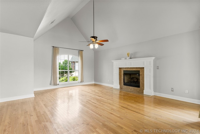 unfurnished living room with a fireplace, light hardwood / wood-style floors, high vaulted ceiling, and ceiling fan