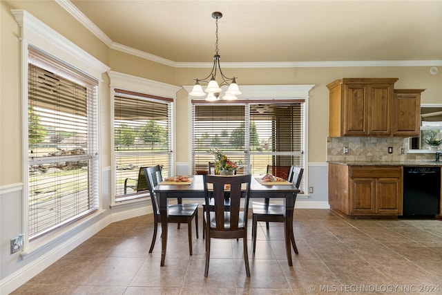 tiled dining space with a healthy amount of sunlight, crown molding, and a chandelier