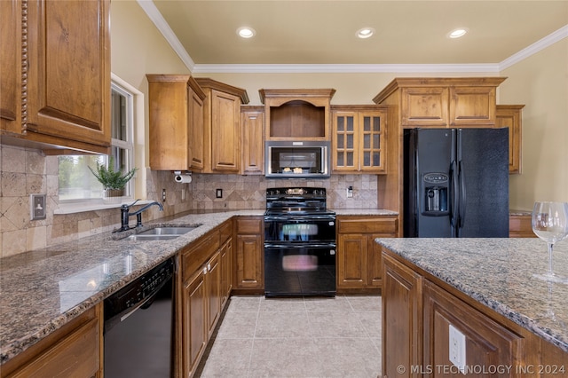 kitchen with black appliances, tasteful backsplash, stone counters, crown molding, and sink