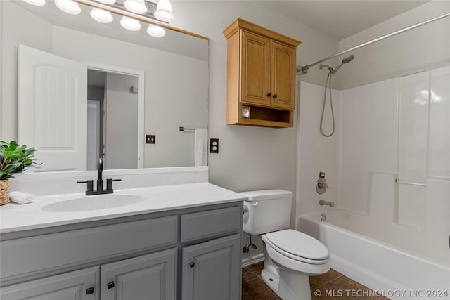 bathroom with toilet, tile patterned flooring,  shower combination, and vanity