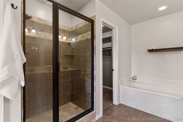 bathroom featuring shower with separate bathtub and tile patterned floors