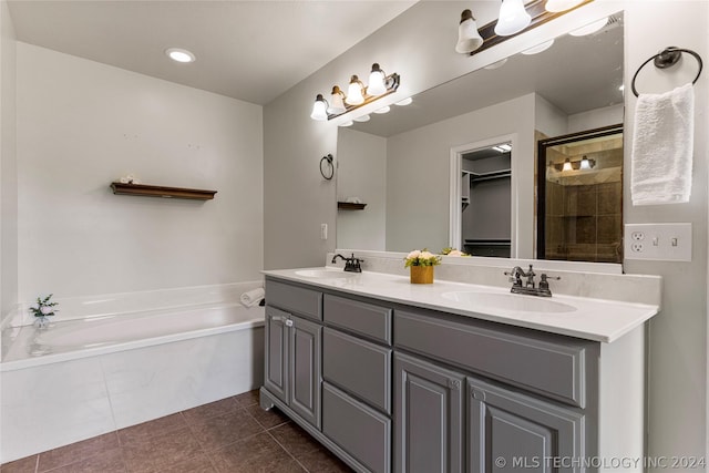 full bathroom with tile patterned floors, tiled shower, a bath, and a sink