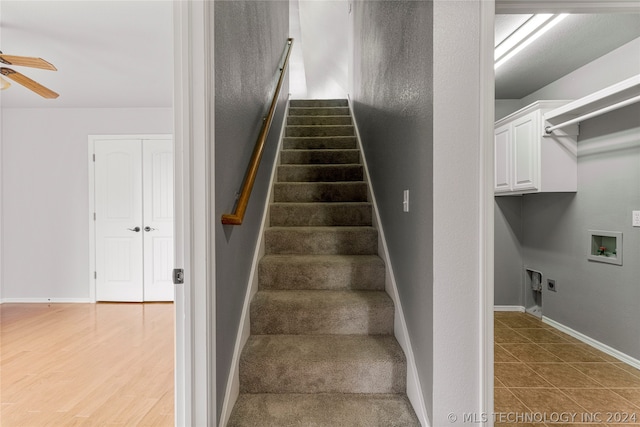 stairway with ceiling fan and hardwood / wood-style flooring