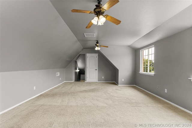 bonus room with lofted ceiling, visible vents, a ceiling fan, and carpet flooring