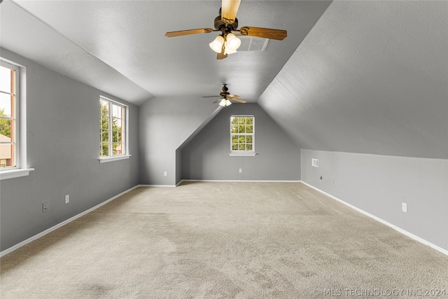 additional living space with baseboards, ceiling fan, carpet floors, and lofted ceiling