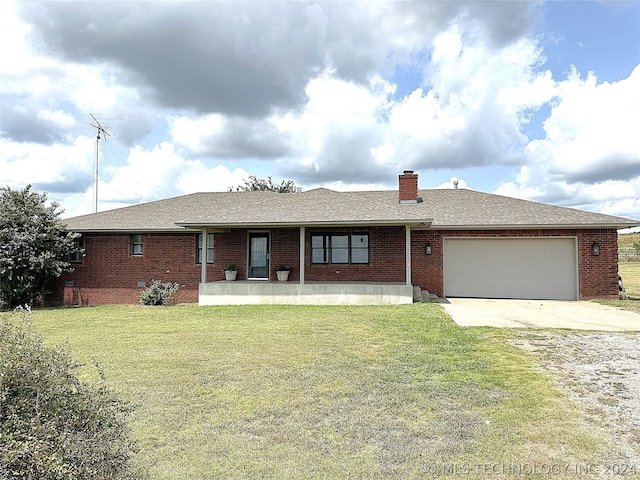 ranch-style home featuring a garage and a front yard