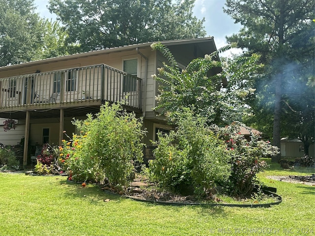 rear view of house featuring a shed and a yard