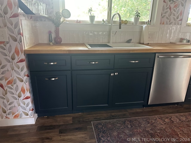 kitchen with stainless steel dishwasher, dark hardwood / wood-style floors, sink, and tasteful backsplash