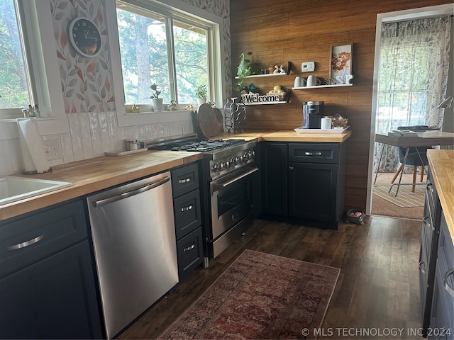 kitchen featuring wood counters, dark wood-type flooring, and stainless steel appliances