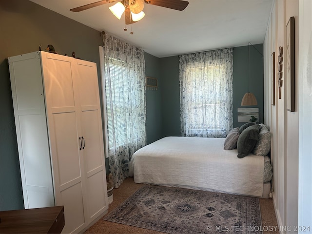 bedroom with ceiling fan, a closet, and carpet flooring