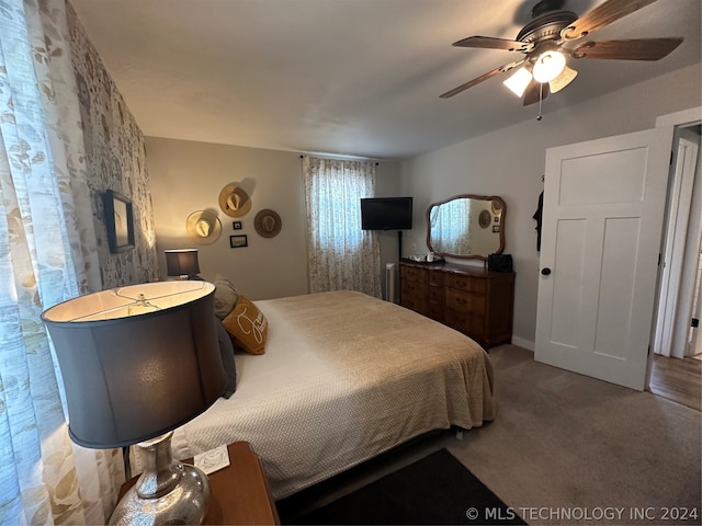 bedroom with ceiling fan and carpet