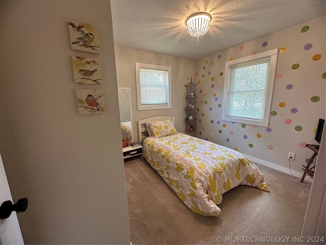 bedroom featuring a textured ceiling and carpet