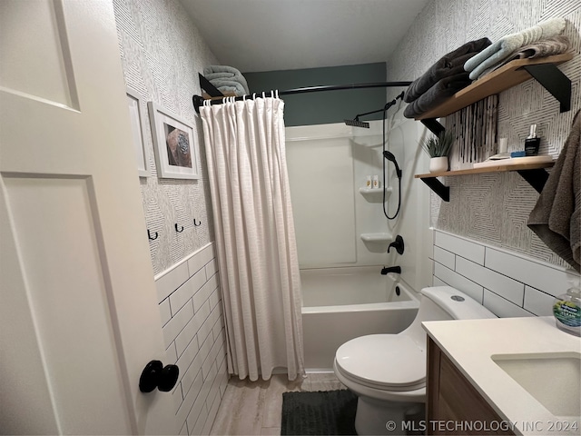 full bathroom with wood-type flooring, vanity, toilet, and shower / bath combo with shower curtain