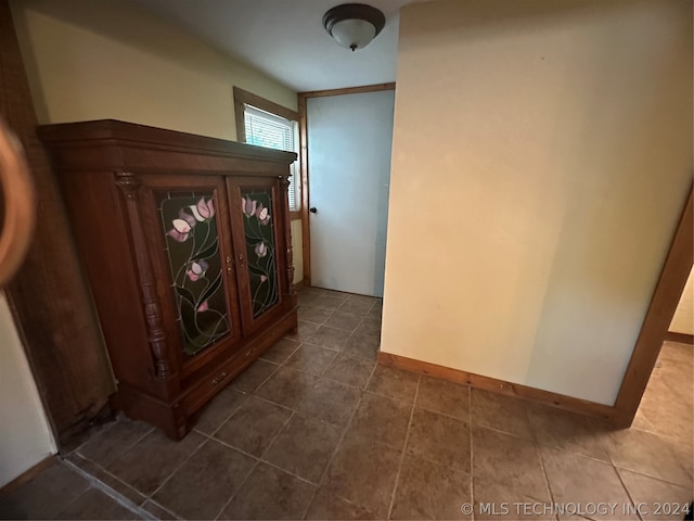 hallway with tile patterned floors