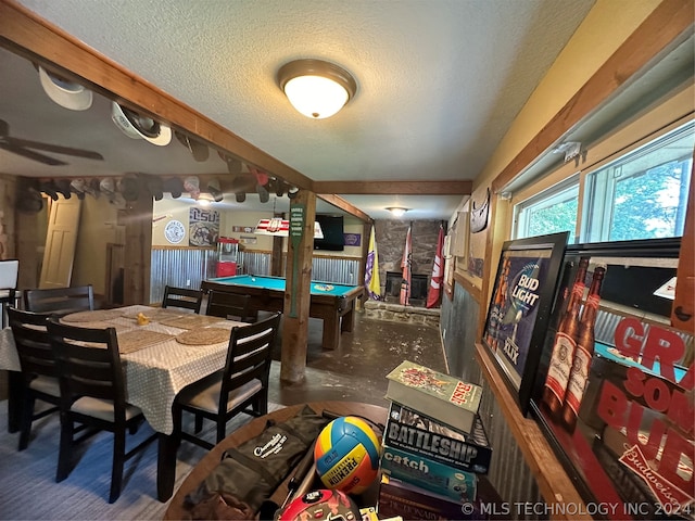 dining space with concrete flooring, a textured ceiling, and billiards