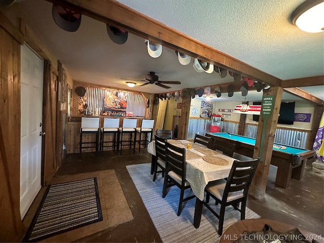 dining area featuring pool table, a textured ceiling, bar area, and ceiling fan