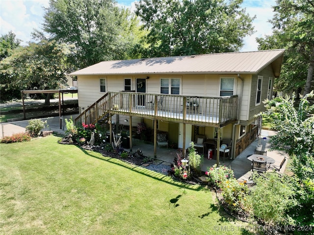 back of property with a lawn, a patio area, and a fire pit