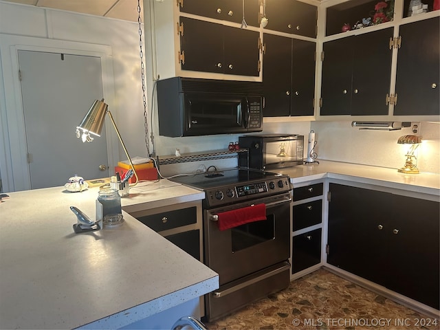 kitchen featuring stove and dark tile patterned flooring