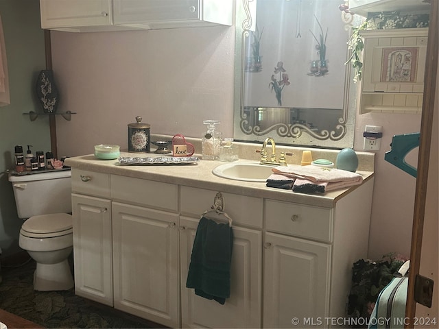 bathroom with vanity and toilet