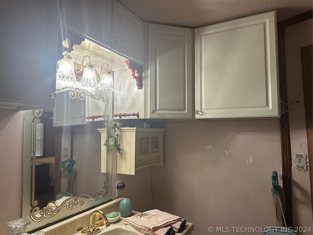 kitchen featuring sink and white cabinetry