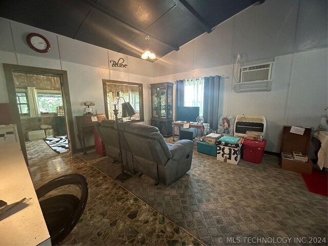 carpeted living room with a wall mounted air conditioner and vaulted ceiling