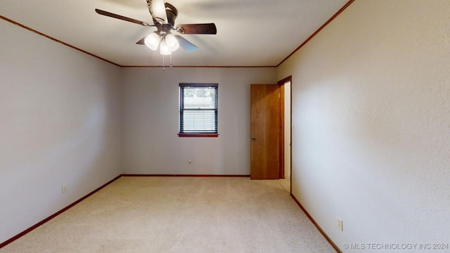 unfurnished room featuring ceiling fan, carpet floors, ornamental molding, and baseboards