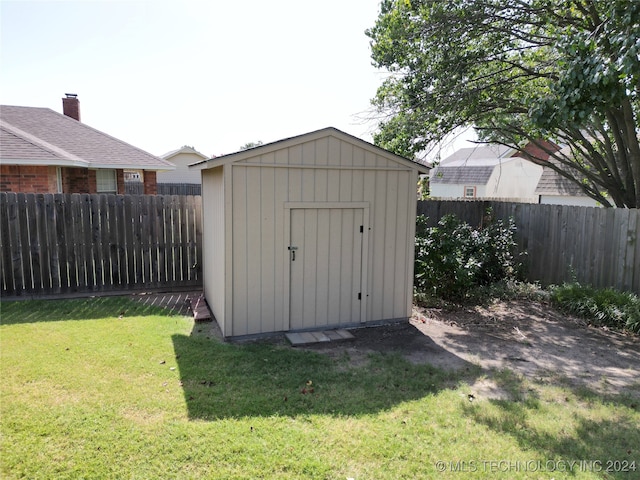 view of shed with a fenced backyard