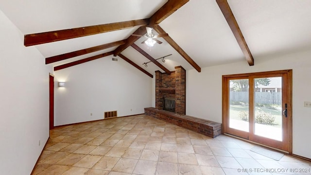 unfurnished living room with vaulted ceiling with beams, ceiling fan, a brick fireplace, and visible vents