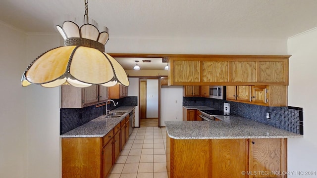 kitchen featuring appliances with stainless steel finishes, backsplash, kitchen peninsula, ornamental molding, and sink